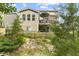 Backyard view of a two-story home with an outdoor seating area, deck, and privacy fence at 4285 Nottinghill Dr, Avon, IN 46123
