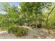 Zen garden with a small bench, foot bridge, and rock landscaping in the fenced-in backyard at 4285 Nottinghill Dr, Avon, IN 46123