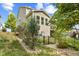Home's backyard with mature trees and landscaping with a black metal fence surrounding the perimeter at 4285 Nottinghill Dr, Avon, IN 46123
