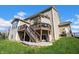 Two-story home showcasing a deck with a pergola and stairs to a paver patio in a well-manicured yard at 4285 Nottinghill Dr, Avon, IN 46123