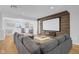 Entertainment basement featuring a large sectional sofa, screen, and accent wall, perfect for Gathering movie nights at 4285 Nottinghill Dr, Avon, IN 46123
