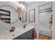 Bright bathroom with double vanity, dual mirrors, and natural wood-style flooring at 4285 Nottinghill Dr, Avon, IN 46123