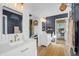 Modern bathroom with white cabinets, herringbone tile, and matte black accent wall to create a unique style at 4285 Nottinghill Dr, Avon, IN 46123