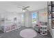 Bright room with custom bunkbed and ceiling fan, filled with soft toys and natural light at 4285 Nottinghill Dr, Avon, IN 46123