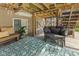Relaxing covered deck featuring gray cushions, teal rug, bench seating and plant at 4285 Nottinghill Dr, Avon, IN 46123