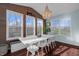 Bright dining room features built-in bench seating, wood wall, and stylish chandelier at 4285 Nottinghill Dr, Avon, IN 46123