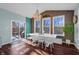 Bright dining room with large windows, wood panel wall and a view to outdoor deck at 4285 Nottinghill Dr, Avon, IN 46123