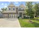 Charming two-story home with a three car garage, brick accents, covered porch, and manicured lawn at 4285 Nottinghill Dr, Avon, IN 46123