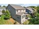 Back exterior view of a tan, two-story home featuring a sunroom addition and second story deck at 4285 Nottinghill Dr, Avon, IN 46123