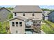 Aerial view of a tan two-story house highlighting a deck with a pergola, dining set, and fenced yard at 4285 Nottinghill Dr, Avon, IN 46123