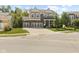 Attractive two-story home featuring a three-car garage, brick accents, covered porch, and landscaped yard at 4285 Nottinghill Dr, Avon, IN 46123