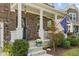 Charming covered porch featuring a wreath, Hello sign, and well-manicured landscaping at 4285 Nottinghill Dr, Avon, IN 46123