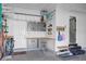Organized garage with storage cabinets, work bench, and convenient shelving units at 4285 Nottinghill Dr, Avon, IN 46123