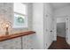 Hallway with wood shelf, botanical wallpaper, motivational quote, and plank accent wall at 4285 Nottinghill Dr, Avon, IN 46123