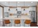 Modern kitchen with white cabinets, brick backsplash, stainless steel appliances and center island with seating at 4285 Nottinghill Dr, Avon, IN 46123