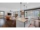 Modern kitchen with a center island, pendant lights, stainless steel appliances and open concept living area at 4285 Nottinghill Dr, Avon, IN 46123