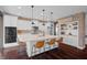 Contemporary kitchen with white cabinets, brick backsplash, stone counters and center island at 4285 Nottinghill Dr, Avon, IN 46123