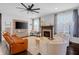 Cozy living room with fireplace, leather sofa, white chairs and lots of natural light at 4285 Nottinghill Dr, Avon, IN 46123