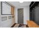 Mud room with black storage, wood bench, white plank wall and organization calendar at 4285 Nottinghill Dr, Avon, IN 46123