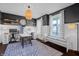 Stylish home office featuring dark accent walls, bright white trim, built in bench, and modern lighting at 4285 Nottinghill Dr, Avon, IN 46123