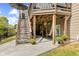 Exterior view from yard showcasing a concrete patio below a wood deck with string lights at 4285 Nottinghill Dr, Avon, IN 46123