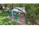 Backyard playground with a slide, rock climbing wall, swings, and a shade covering at 4285 Nottinghill Dr, Avon, IN 46123