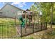 Backyard playground with slide and swing set is fenced in for safety and located on a grassy lawn at 4285 Nottinghill Dr, Avon, IN 46123