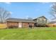 View of the backyard featuring the house, patio with grill, lawn and wooden fence at 470 Waterford Dr, Zionsville, IN 46077