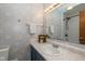 Updated bathroom with blue tiled wall, sink, toilet, and mirror at 470 Waterford Dr, Zionsville, IN 46077