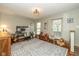 Bright bedroom with large windows, hardwood floors, patterned rug, and a dedicated workspace at 470 Waterford Dr, Zionsville, IN 46077