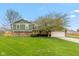 Charming home showcasing a brick facade, a well-manicured lawn and an attached two car garage at 470 Waterford Dr, Zionsville, IN 46077