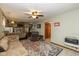 View of living room with staircase, access to kitchen, and hardwood floors with area rug at 470 Waterford Dr, Zionsville, IN 46077