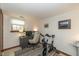 Office with desk, computer monitors, stationary bike, and art at 470 Waterford Dr, Zionsville, IN 46077
