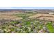 Aerial view of a neighborhood with homes, green grass, fields and trees at 5132 W Blue Bell Dr, New Palestine, IN 46163