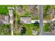 Aerial view of a well-maintained home with a large yard, surrounded by mature trees and a neighborhood street at 5132 W Blue Bell Dr, New Palestine, IN 46163
