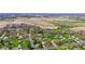 Aerial view of a neighborhood with homes, green grass, trees and farm land at 5132 W Blue Bell Dr, New Palestine, IN 46163