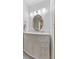 Bathroom vanity with white countertop, drawers, oval mirror and modern vanity lighting at 5132 W Blue Bell Dr, New Palestine, IN 46163