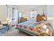 Inviting bedroom with two windows, a bed with a patterned quilt, and carpet flooring that promotes a cozy atmosphere at 5132 W Blue Bell Dr, New Palestine, IN 46163