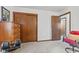 Bedroom with wooden closet doors, dresser, desk and chair at 5132 W Blue Bell Dr, New Palestine, IN 46163