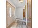 Inviting entryway with decorative front doors, light wood flooring, and ample natural light at 5132 W Blue Bell Dr, New Palestine, IN 46163