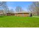 Single story home with a brick exterior, mature landscaping, and an attached garage at 5132 W Blue Bell Dr, New Palestine, IN 46163
