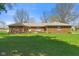 Charming single-story brick home with a well-manicured lawn and mature trees at 5132 W Blue Bell Dr, New Palestine, IN 46163