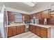 Functional kitchen with wood cabinets, stainless steel appliances, and a view of the outdoors at 5132 W Blue Bell Dr, New Palestine, IN 46163