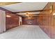 Large living room featuring a brick fireplace, wood trim, and neutral carpet at 5132 W Blue Bell Dr, New Palestine, IN 46163