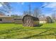 Backyard featuring three outbuildings for storage on a lush green lawn at 5132 W Blue Bell Dr, New Palestine, IN 46163