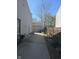 Backyard featuring a concrete path leading to detached garage with wooden fencing at 5338 Traditions Dr, Indianapolis, IN 46235