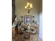 Charming dining area with a decorative chandelier and inviting table setting at 5338 Traditions Dr, Indianapolis, IN 46235