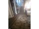 Hallway leading to the stairway featuring carpet, neutral walls, and storage room at 5338 Traditions Dr, Indianapolis, IN 46235