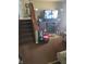Spacious living room with carpet, entertainment center, and staircase at 5338 Traditions Dr, Indianapolis, IN 46235