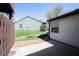 A backyard features a stone patio area, with an air conditioning unit on the side of the house, adjacent to grassy yard space at 562 Monte Vista Dr, Greenwood, IN 46143